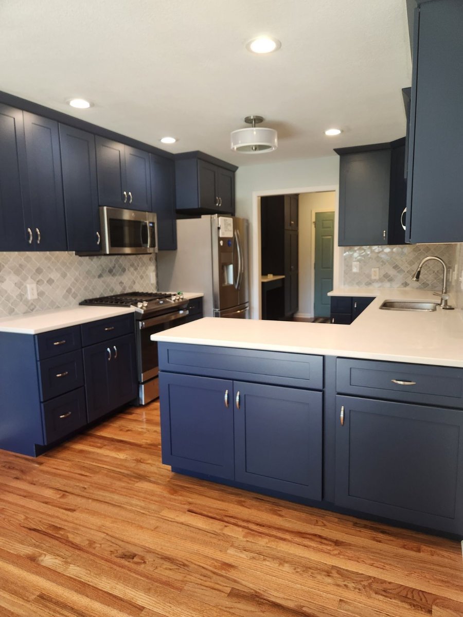 Kitchen Remodel With White Countertops and Blue Custom Cabinetry With Stainless Steel Fixtures By True Craft Remodelers