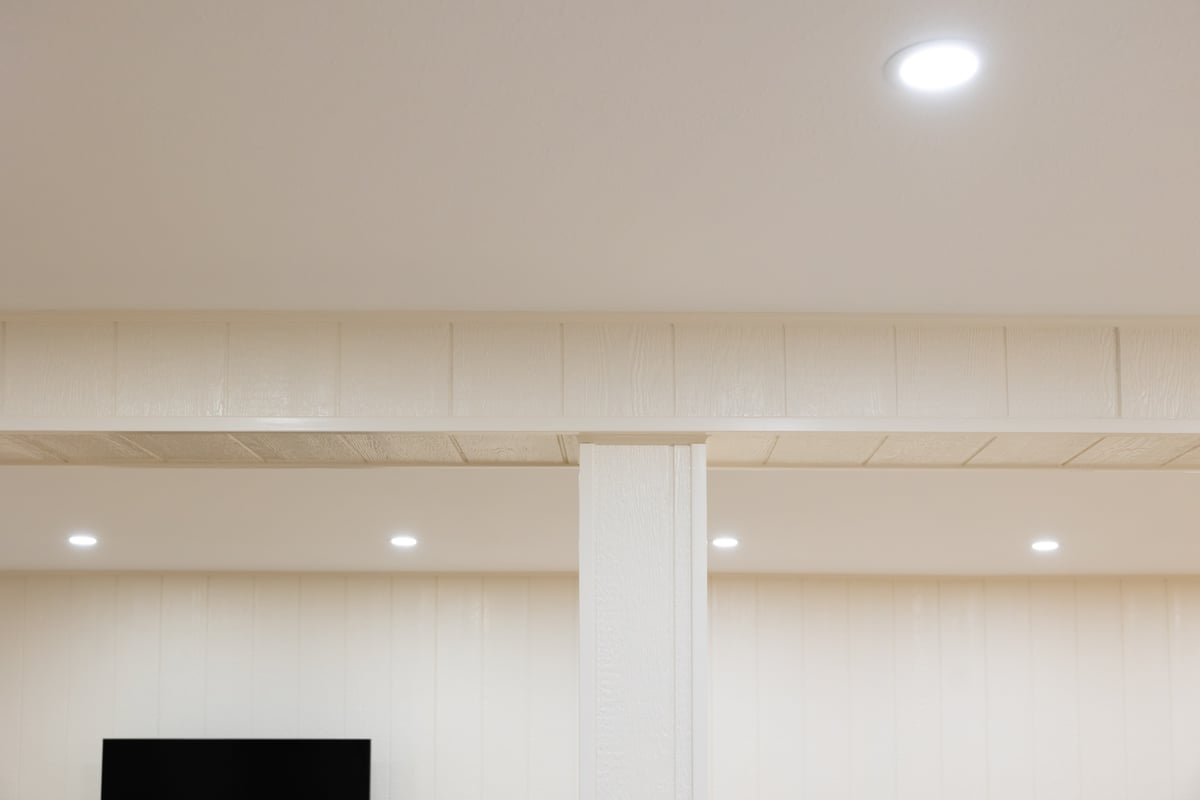 Recessed lighting in bight white open basement remodel