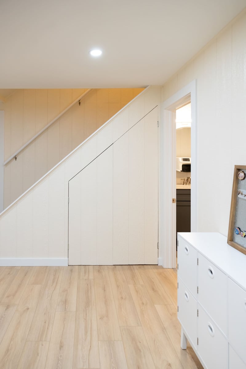 Under stairs closet and doorway to bathoom in basement remodel